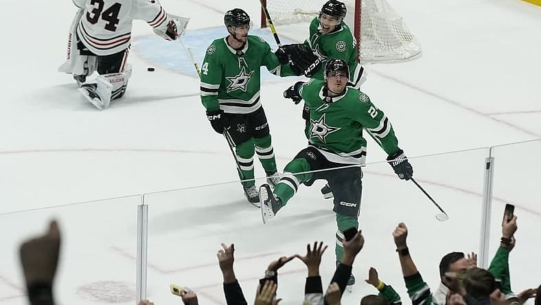 Dec 29, 2023; Dallas, Texas, USA; Dallas Stars center Roope Hintz (24) reacts with defenseman Miro Heiskanen (4) and left wing Jason Robertson (21) in front of Chicago Blackhawks goaltender Petr Mrazek (34) after scoring the game winning goal during overtime at American Airlines Center. Mandatory Credit: Raymond Carlin III-USA TODAY Sports
