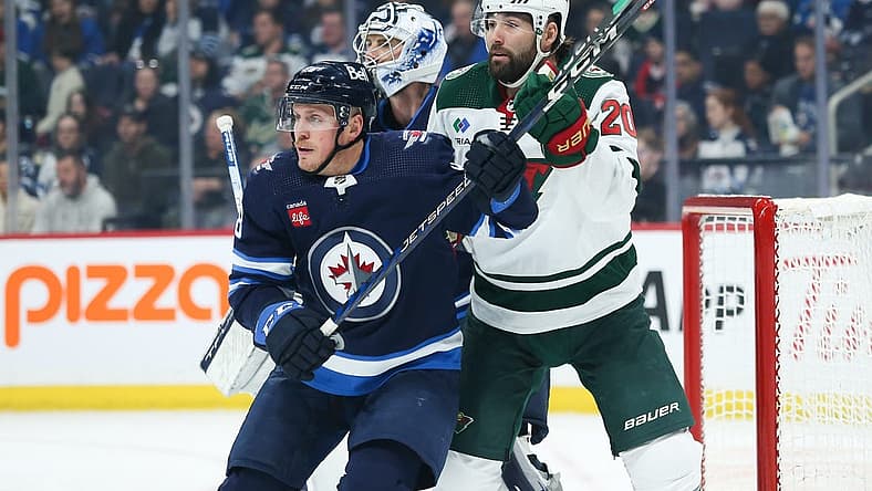 Dec 30, 2023; Winnipeg, Manitoba, CAN; Winnipeg Jets defenseman Nate Schmidt (88) jostles for position with Minnesota Wild forward Patrick Maroon (20) in front of goaltender Connor Hellebuyck (37) during the first period at Canada Life Centre. Mandatory Credit: Terrence Lee-USA TODAY Sports