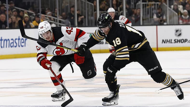 Dec 30, 2023; Boston, Massachusetts, USA; Boston Bruins center Pavel Zacha (18) races New Jersey Devils defenseman Luke Hughes (43) for a loose puck during the first period at TD Garden. Mandatory Credit: Winslow Townson-USA TODAY Sports