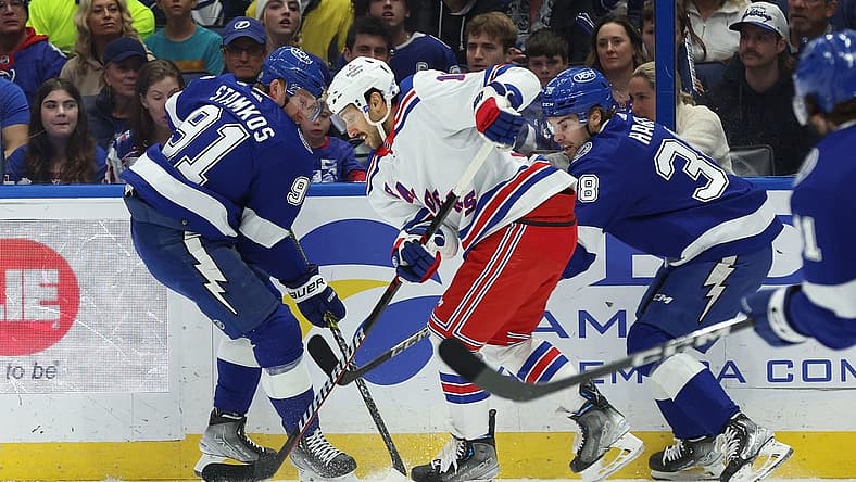 Dec 30, 2023; Tampa, Florida, USA;New York Rangers center Vincent Trocheck (16) skate with the puck as Tampa Bay Lightning center Steven Stamkos (91) and Tampa Bay Lightning left wing Brandon Hagel (38) defend during the first period at Amalie Arena. Mandatory Credit: Kim Klement Neitzel-USA TODAY Sports