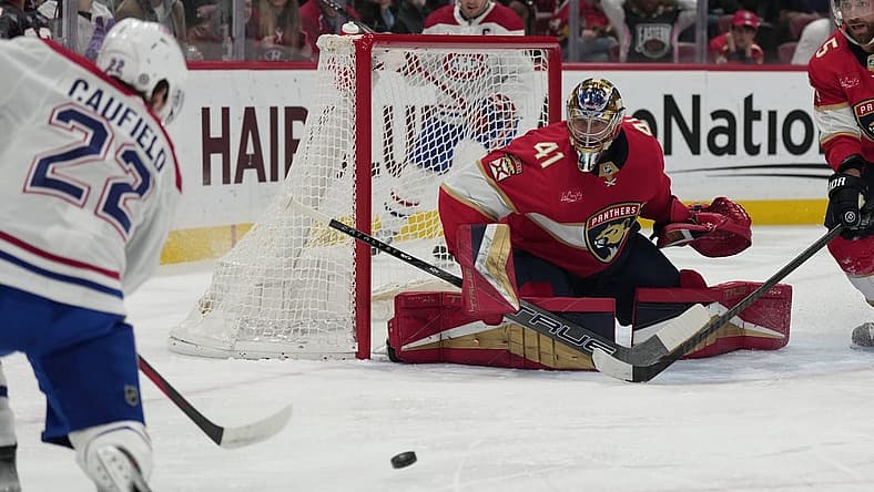 Dec 30, 2023; Sunrise, Florida, USA; Montreal Canadiens right wing Cole Caufield (22) takes a shot at goal as Florida Panthers goaltender Anthony Stolarz (41) defends during the first period at Amerant Bank Arena. Mandatory Credit: Jim Rassol-USA TODAY Sports