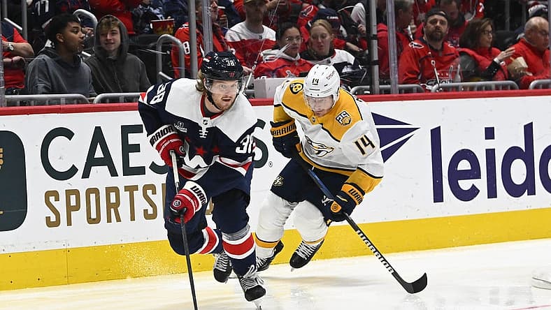 Dec 30, 2023; Washington, District of Columbia, USA; Washington Capitals defenseman Rasmus Sandin (38) advances the puck as Nashville Predators center Gustav Nyquist (14) chases during the second period at Capital One Arena. Mandatory Credit: Brad Mills-USA TODAY Sports