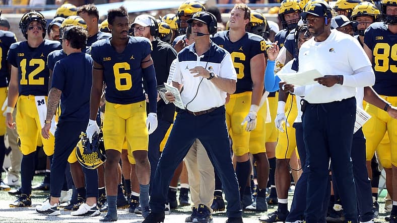 Outgoing head coach Jim Harbaugh endorsed offensive coordinator Sherrone Moore, right, as the next coach of the Wolverines.