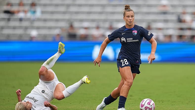 Aug 19, 2023; San Diego, California, USA; San Diego Wave FC midfielder Meggie Dougherty Howard (28) dribbles past NJ/NY Gotham FC midfielder Jenna Nighswonger (32) during the first half at Snapdragon Stadium. Mandatory Credit: Ray Acevedo-USA TODAY Sports