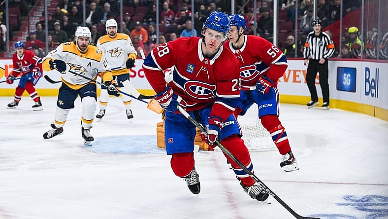 Dec 10, 2023; Montreal, Quebec, CAN; Montreal Canadiens center Christian Dvorak (28) plays the puck against the Nashville Predators during the first period at Bell Centre. Mandatory Credit: David Kirouac-USA TODAY Sports