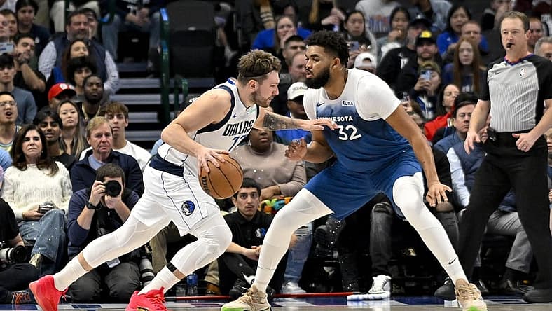 Jan 7, 2024; Dallas, Texas, USA; Dallas Mavericks guard Luka Doncic (77) drives to the basket past Minnesota Timberwolves center Karl-Anthony Towns (32) during the second quarter at the American Airlines Center. Mandatory Credit: Jerome Miron-USA TODAY Sports