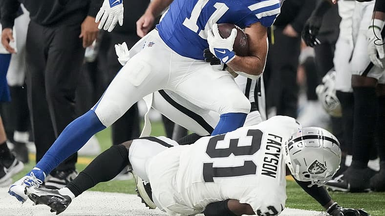 Dec 31, 2023; Indianapolis, Indiana, USA; Indianapolis Colts wide receiver Michael Pittman Jr. (11) runs out of bounds as Las Vegas Raiders cornerback Brandon Facyson (31) rolls at his feet during a game against the Las Vegas Raiders at Lucas Oil Stadium. Mandatory Credit: Bob Scheer-USA TODAY Sports