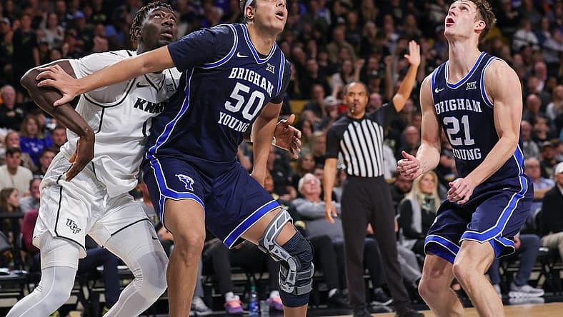 Jan 13, 2024; Orlando, Florida, USA; Brigham Young Cougars center Aly Khalifa (50) guard Trevin Knell (21) and UCF Knights forward Ibrahima Diallo (11) look for the rebound during the second half at Addition Financial Arena. Mandatory Credit: Mike Watters-USA TODAY Sports