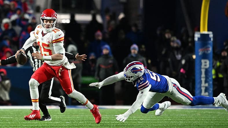 Jan 21, 2024; Orchard Park, New York, USA; Kansas City Chiefs quarterback Patrick Mahomes (15) rushes the ball past Buffalo Bills defensive end Leonard Floyd (56) in the second half of the 2024 AFC divisional round game at Highmark Stadium. Mandatory Credit: Mark Konezny-USA TODAY Sports