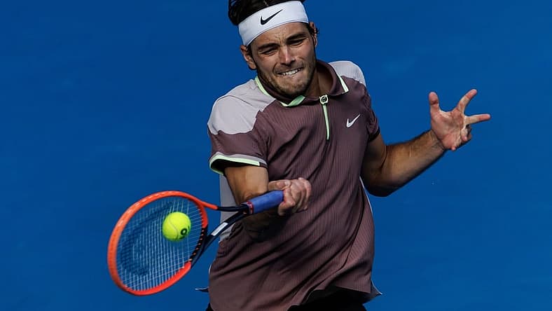 Jan 23, 2024; Melbourne, Victoria, Australia;
Taylor Fritz of the United States in action against Novak Djokovic of Serbia in the quarter final of the men s singles. Mandatory Credit: Mike Frey-USA TODAY Sports
