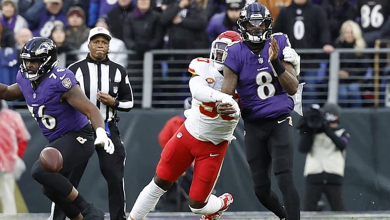 Jan 28, 2024; Baltimore, Maryland, USA; Kansas City Chiefs defensive end Charles Omenihu (90) strips the ball from Baltimore Ravens quarterback Lamar Jackson (8) in the AFC Championship football game at M&T Bank Stadium. Mandatory Credit: Geoff Burke-USA TODAY Sports