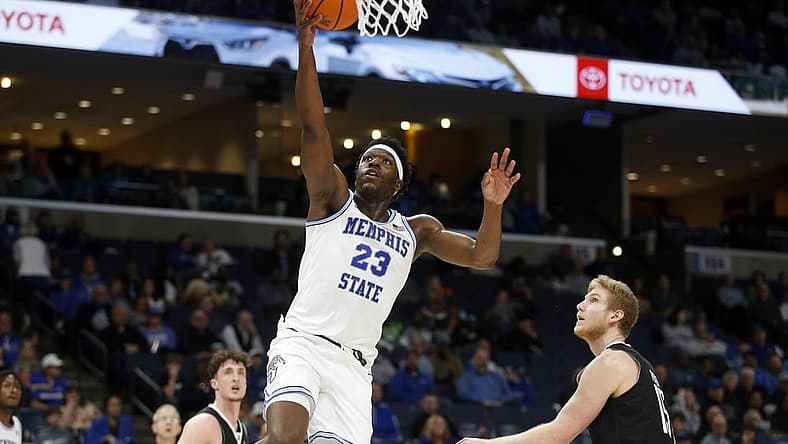 Jan 31, 2024; Memphis, Tennessee, USA; Memphis Tigers forward Malcolm Dandridge (23) drives to the basket as Rice Owls forward Max Fiedler (15) defends during the first half at FedExForum. Mandatory Credit: Petre Thomas-USA TODAY Sports