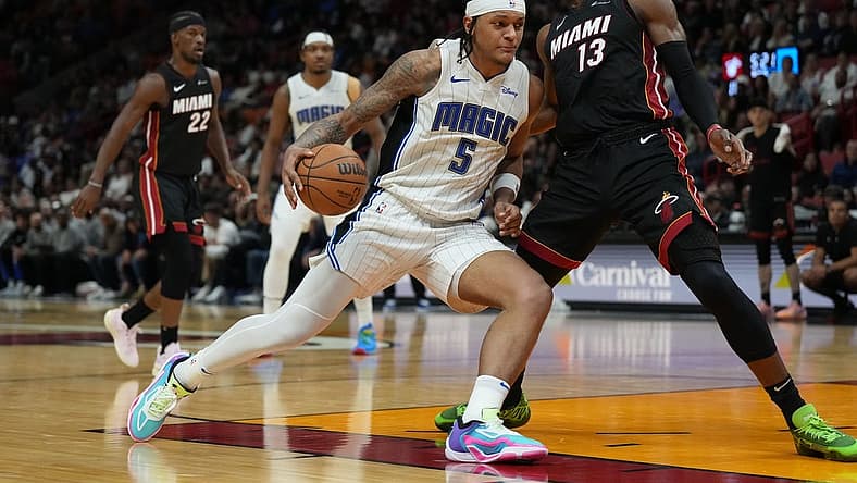 Feb 6, 2024; Miami, Florida, USA; Orlando Magic forward Paolo Banchero (5) drives to the basket as Miami Heat center Bam Adebayo (13) defends during the second half at Kaseya Center. Mandatory Credit: Jim Rassol-USA TODAY Sports