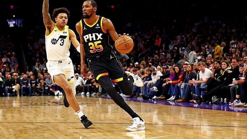 Feb 8, 2024; Phoenix, Arizona, USA; Phoenix Suns forward Kevin Durant (35) drives to the basket against Utah Jazz guard Keyonte George (3) during the third quarter at Footprint Center. Mandatory Credit: Mark J. Rebilas-USA TODAY Sports