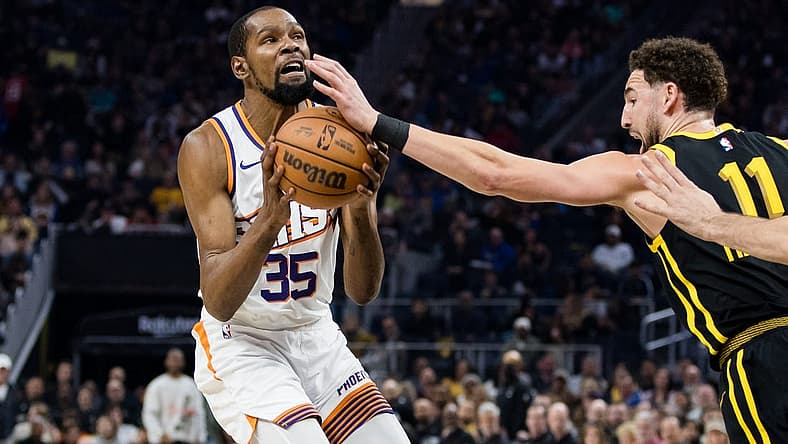 Feb 10, 2024; San Francisco, California, USA; Phoenix Suns forward Kevin Durant (35) is defended by Golden State Warriors guard Klay Thompson (11) during the first half at Chase Center. Mandatory Credit: John Hefti-USA TODAY Sports