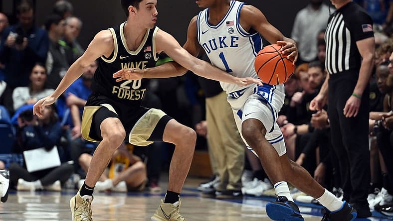 Feb 12, 2024; Durham, North Carolina, USA; Duke Blue Devils guard Caleb Foster (1) controls the ball in front of Wake Forest Deamon Deacons guard Parker Friedrichsen (20) during the first half at Cameron Indoor Stadium. Mandatory Credit: Rob Kinnan-USA TODAY Sports