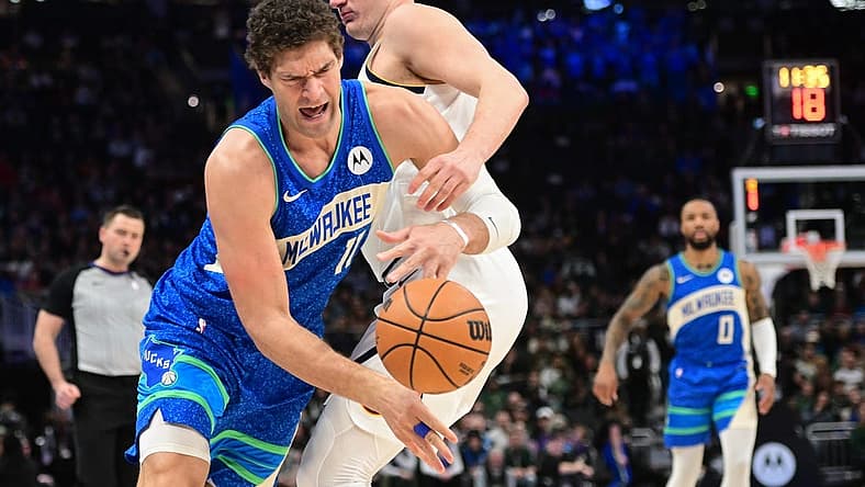 Feb 12, 2024; Milwaukee, Wisconsin, USA; Milwaukee Bucks center Brook Lopez (11) tries to get past Denver Nuggets center Nikola Jokic (15) in the first quarter at Fiserv Forum. Mandatory Credit: Benny Sieu-USA TODAY Sports