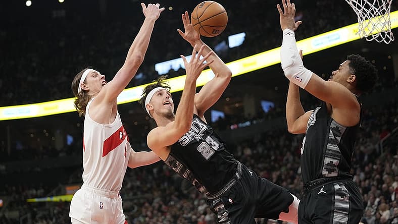 Feb 12, 2024; Toronto, Ontario, CAN; Toronto Raptors forward Kelly Olynyk (41) and San Antonio Spurs forward Zach Collins (23) and forward Keldon Johnson (3) battle for a rebound during the first half at Scotiabank Arena. Mandatory Credit: John E. Sokolowski-USA TODAY Sports