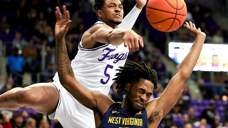 Feb 12, 2024; Fort Worth, Texas, USA; TCU Horned Frogs forward Chuck O'Bannon Jr. (5) defends the shot of West Virginia Mountaineers guard Jeremiah Bembry (5) during the second half at Ed and Rae Schollmaier Arena. Mandatory Credit: Kevin Jairaj-USA TODAY Sports