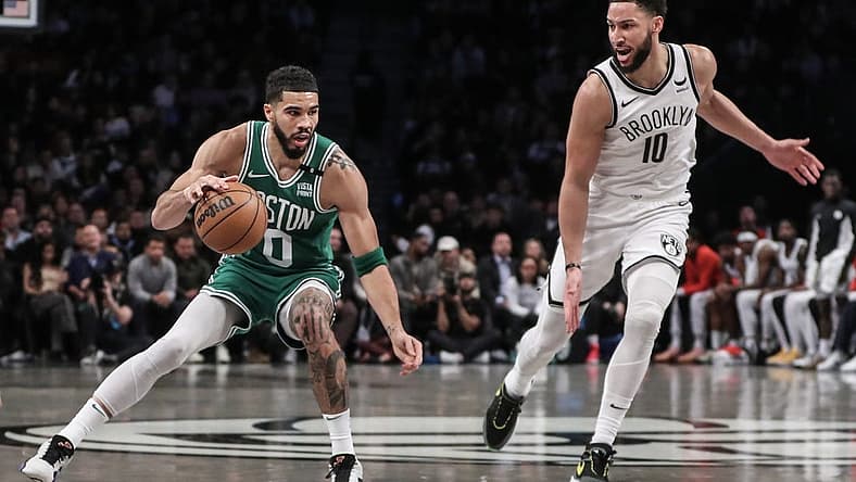 Feb 13, 2024; Brooklyn, New York, USA; Boston Celtics forward Jayson Tatum (0) looks to drive past Brooklyn Nets guard Ben Simmons (10) in the second quarter at Barclays Center. Mandatory Credit: Wendell Cruz-USA TODAY Sports