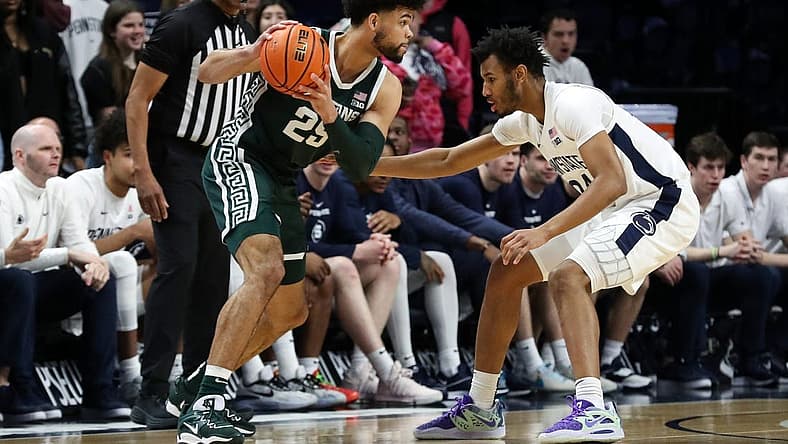 Feb 14, 2024; University Park, Pennsylvania, USA; Michigan State Spartans forward Malik Hall (25) holds the ball as Penn State Nittany Lions forward Zach Hicks (24) defends during the first half at Bryce Jordan Center. Mandatory Credit: Matthew O'Haren-USA TODAY Sports