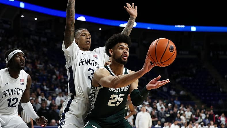 Feb 14, 2024; University Park, Pennsylvania, USA; Michigan State Spartans forward Malik Hall (25) passes the ball as Penn State Nittany Lions guard Nick Kern Jr (3) defends during the second half at Bryce Jordan Center. Michigan State defeated Penn State 80-72. Mandatory Credit: Matthew O'Haren-USA TODAY Sports