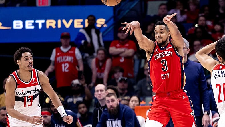 Feb 14, 2024; New Orleans, Louisiana, USA; New Orleans Pelicans guard CJ McCollum (3) passes the ball against Washington Wizards guard Jordan Poole (13) during the second half at Smoothie King Center. Mandatory Credit: Stephen Lew-USA TODAY Sports