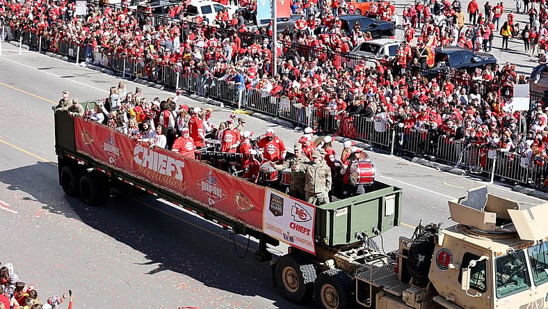 Feb 14, 2024; Kansas City, MO, USA; Fan watch the parade procession during the celebration of the Kansas City Chiefs winning Super Bowl LVIII. Mandatory Credit: Julia Kapros-USA TODAY Sports