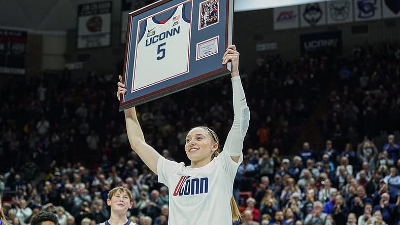 Feb 16, 2024; Storrs, Connecticut, USA; UConn Huskies guard Paige Bueckers (5) holds up her jersey during senior night after defeating the Georgetown Hoyas at Harry A. Gampel Pavilion. Mandatory Credit: David Butler II-USA TODAY Sports