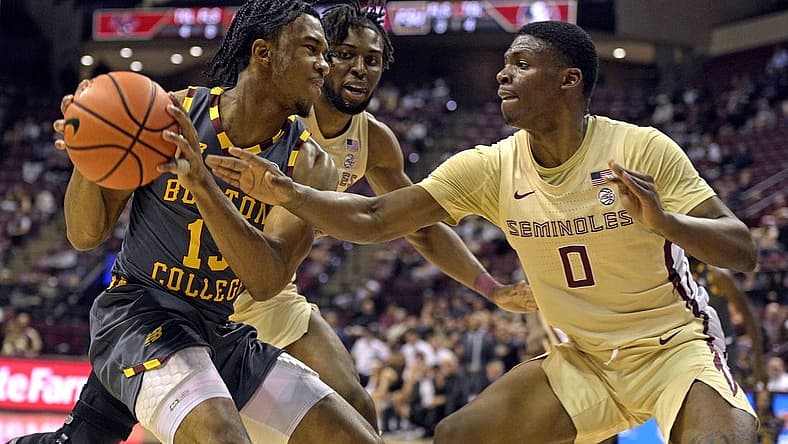 Feb 20, 2024; Tallahassee, Florida, USA; Boston College Eagles guard Donald Hand Jr. (13) is pressured by Florida State Seminoles guard Chandler Jackson (0) during the first half at Donald L. Tucker Center. Mandatory Credit: Melina Myers-USA TODAY Sports