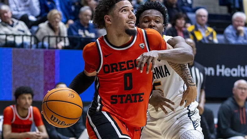 February 22, 2024; Berkeley, California, USA; Oregon State Beavers guard Jordan Pope (0) dribbles the basketball against California Golden Bears guard Jalen Cone (15) during the second half at Haas Pavilion. Mandatory Credit: Kyle Terada-USA TODAY Sports