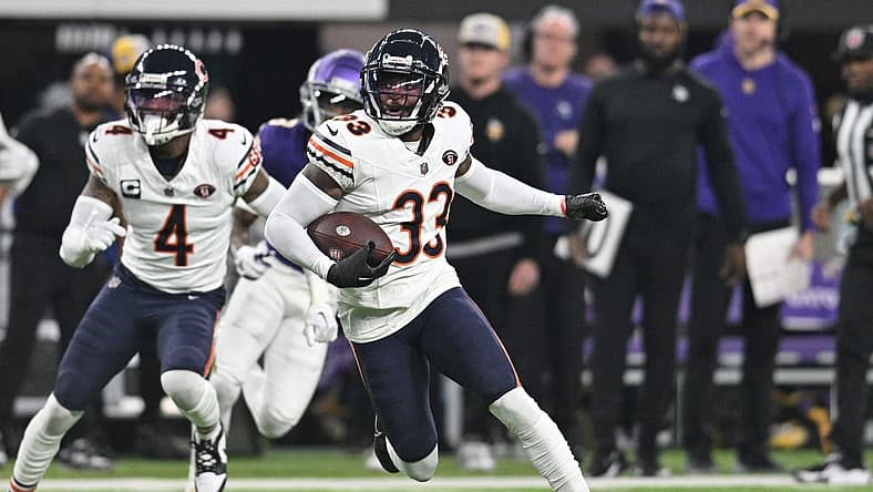 Nov 27, 2023; Minneapolis, Minnesota, USA; Chicago Bears cornerback Jaylon Johnson (33) returns an interception as safety Eddie Jackson (4) looks on against the Minnesota Vikings during the second quarter at U.S. Bank Stadium. Mandatory Credit: Jeffrey Becker-USA TODAY Sports