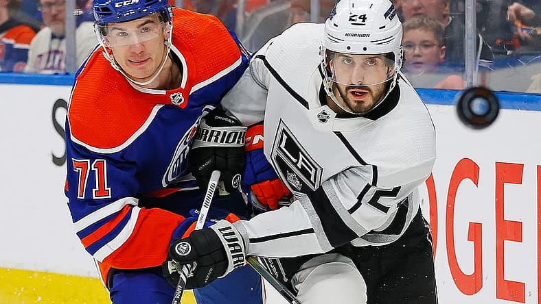 Feb 26, 2024; Edmonton, Alberta, CAN; Edmonton Oilers forward Ryan McLeod (71) and Los Angeles Kings forward Phillip Danault (24) follow a loose puck during the second period at Rogers Place. Mandatory Credit: Perry Nelson-USA TODAY Sports