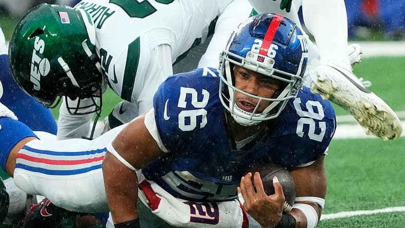 New York Giants running back Saquon Barkley (26) is shown with the ball against the Jets. The Giants' star running back is on the verge of hitting free agency and there is plenty of debate over his uncertain future with Big Blue.