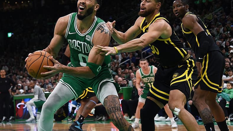 Mar 3, 2024; Boston, Massachusetts, USA; Boston Celtics forward Jayson Tatum (0) controls the ball while Golden State Warriors guard Stephen Curry (30) defends during the first half at TD Garden. Mandatory Credit: Bob DeChiara-USA TODAY Sports