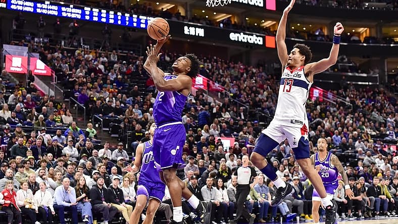 Mar 4, 2024; Salt Lake City, Utah, USA; Utah Jazz guard Collin Sexton (2) takes a shot around Washington Wizards guard Jordan Poole (13) during the second half at the Delta Center. Mandatory Credit: Christopher Creveling-USA TODAY Sports