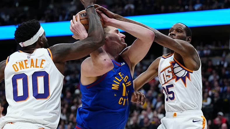 Mar 5, 2024; Denver, Colorado, USA; Phoenix Suns forward Kevin Durant (35) and forward Royce O'Neale (00) defend Denver Nuggets center Nikola Jokic (15) in the first half at Ball Arena. Mandatory Credit: Ron Chenoy-USA TODAY Sports