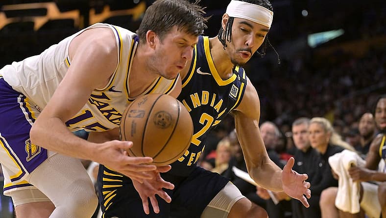 Mar 24, 2024; Los Angeles, California, USA; Los Angeles Lakers guard Austin Reaves (15) and Indiana Pacers guard Andrew Nembhard (2) go for the ball in the second half at Crypto.com Arena. Mandatory Credit: Jayne Kamin-Oncea-USA TODAY Sports