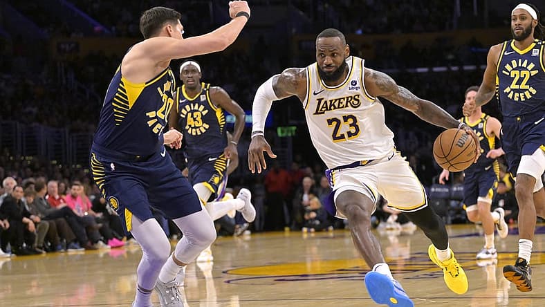 Mar 24, 2024; Los Angeles, California, USA; Los Angeles Lakers forward LeBron James (23) drives past Indiana Pacers forward Doug McDermott (20) in the second half at Crypto.com Arena. Mandatory Credit: Jayne Kamin-Oncea-USA TODAY Sports