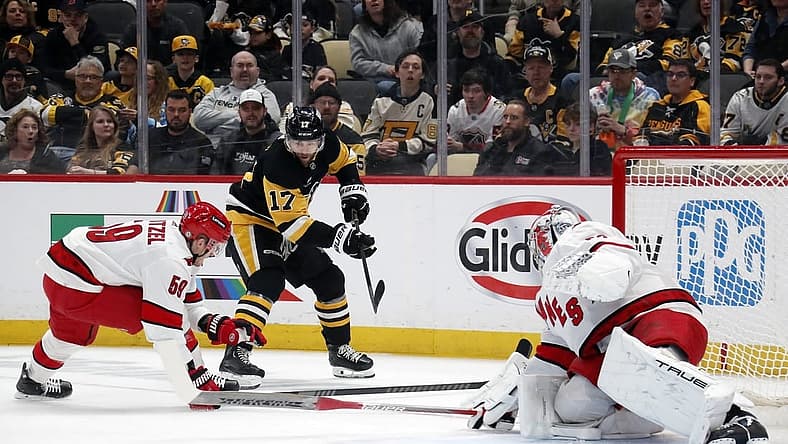 Mar 26, 2024; Pittsburgh, Pennsylvania, USA; Carolina Hurricanes left wing Jake Guentzel (59) and goaltender Pyotr Kochetkov (52) defend Pittsburgh Penguins right wing Bryan Rust (17) during the first period at PPG Paints Arena. Mandatory Credit: Charles LeClaire-USA TODAY Sports