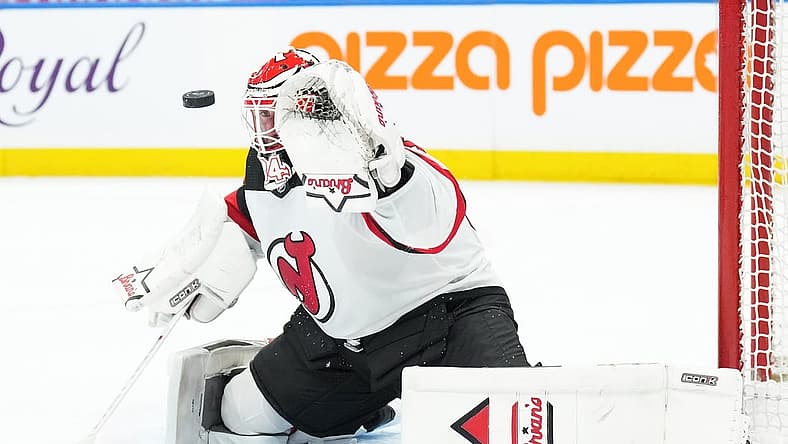 Mar 26, 2024; Toronto, Ontario, CAN; New Jersey Devils goaltender Jake Allen (34) attempts to stop the puck against the Toronto Maple Leafs during the first period at Scotiabank Arena. Mandatory Credit: Nick Turchiaro-USA TODAY Sports