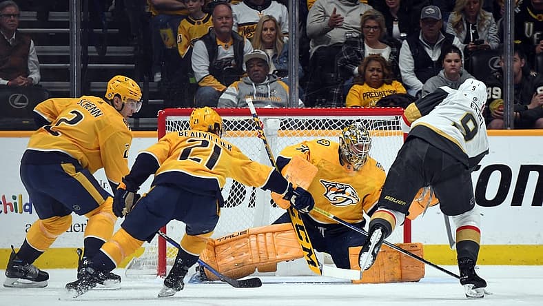 Mar 26, 2024; Nashville, Tennessee, USA; Nashville Predators goaltender Juuse Saros (74) makes a save on a shot by Vegas Golden Knights center Jack Eichel (9) during the first period at Bridgestone Arena. Mandatory Credit: Christopher Hanewinckel-USA TODAY Sports