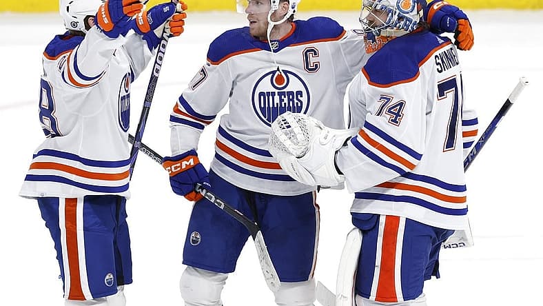 Mar 26, 2024; Winnipeg, Manitoba, CAN; Edmonton Oilers right wing Connor Brown (28), Edmonton Oilers center Connor McDavid (97) and Edmonton Oilers goaltender Stuart Skinner (74) celebrate their overtime victory against the Winnipeg Jets at Canada Life Centre. Mandatory Credit: James Carey Lauder-USA TODAY Sports