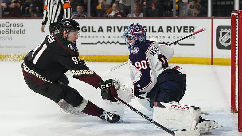 Mar 26, 2024; Tempe, Arizona, USA; Columbus Blue Jackets goaltender Elvis Merzlikins (90) makes the save on Arizona Coyotes right wing Josh Doan (91) in the second period at Mullett Arena. Mandatory Credit: Rick Scuteri-USA TODAY Sports