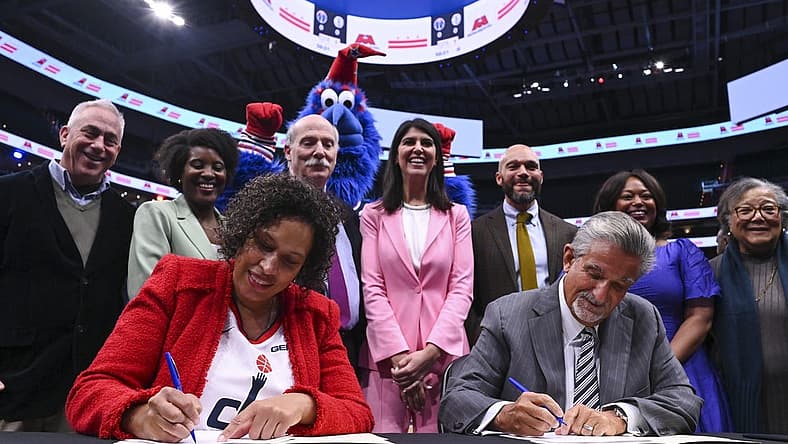 Mar 27, 2024; Washington, District of Columbia, USA; Washington DC mayor Muriel Bowser and Monumental Sports & Entertainment CEO Ted Leonsis sign an agreement on the court before the game between the Brooklyn Nets and the Washington Wizards at Capital One Arena. Mandatory Credit: Tommy Gilligan-USA TODAY Sports