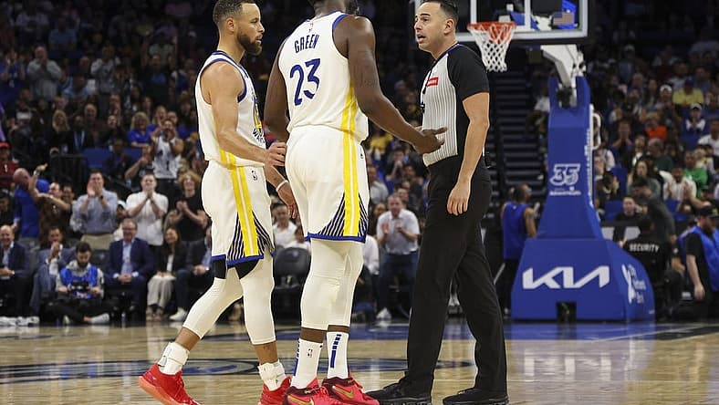 Mar 27, 2024; Orlando, Florida, USA; Golden State Warriors forward Draymond Green (23) talks to referee Ray Acosta (54) after receiving a foul in the first quarter at the Kia Center. Mandatory Credit: Nathan Ray Seebeck-USA TODAY Sports