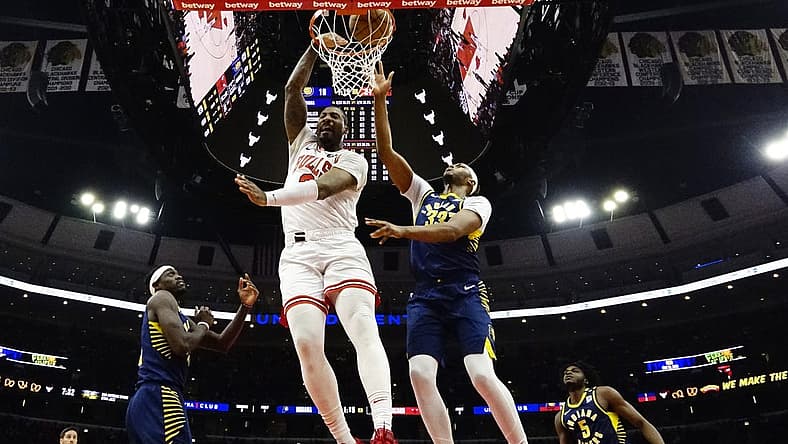 Mar 27, 2024; Chicago, Illinois, USA; Chicago Bulls center Andre Drummond (3) dunks on Indiana Pacers center Myles Turner (33) during the first quarter at United Center. Mandatory Credit: David Banks-USA TODAY Sports