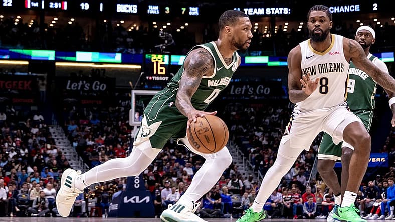 Mar 28, 2024; New Orleans, Louisiana, USA; Milwaukee Bucks guard Damian Lillard (0) dribbles against New Orleans Pelicans forward Naji Marshall (8) during the first half at Smoothie King Center. Mandatory Credit: Stephen Lew-USA TODAY Sports