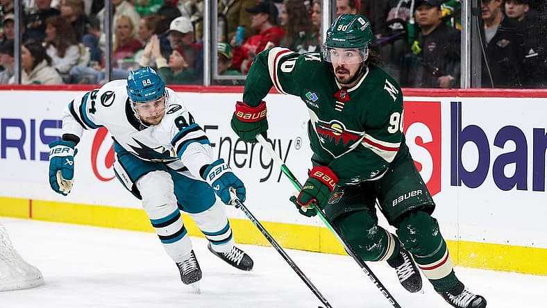 Mar 28, 2024; Saint Paul, Minnesota, USA; Minnesota Wild center Marcus Johansson (90) skates with the puck as San Jose Sharks defenseman Jan Rutta (84) defends during the second period at Xcel Energy Center. Mandatory Credit: Matt Krohn-USA TODAY Sports