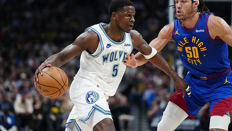 Mar 29, 2024; Denver, Colorado, USA; Minnesota Timberwolves guard Anthony Edwards (5) drives at Denver Nuggets forward Aaron Gordon (50) in the second quarter at Ball Arena. Mandatory Credit: Ron Chenoy-USA TODAY Sports